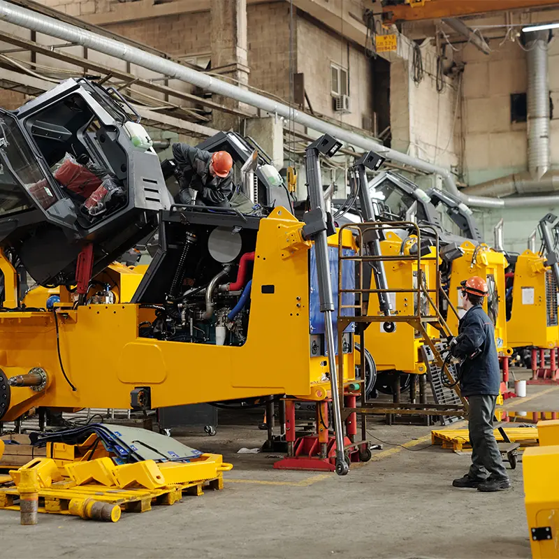 Technician servicing heavy construction equipment in Al Saha's UAE workshop for AdBlue delete
