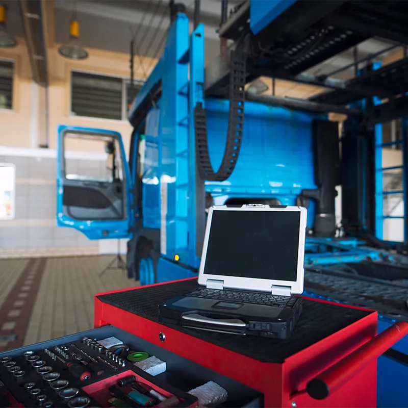ECU programming diagnostic setup with laptop and equipment at Al Saha's heavy vehicle workshop in UAE